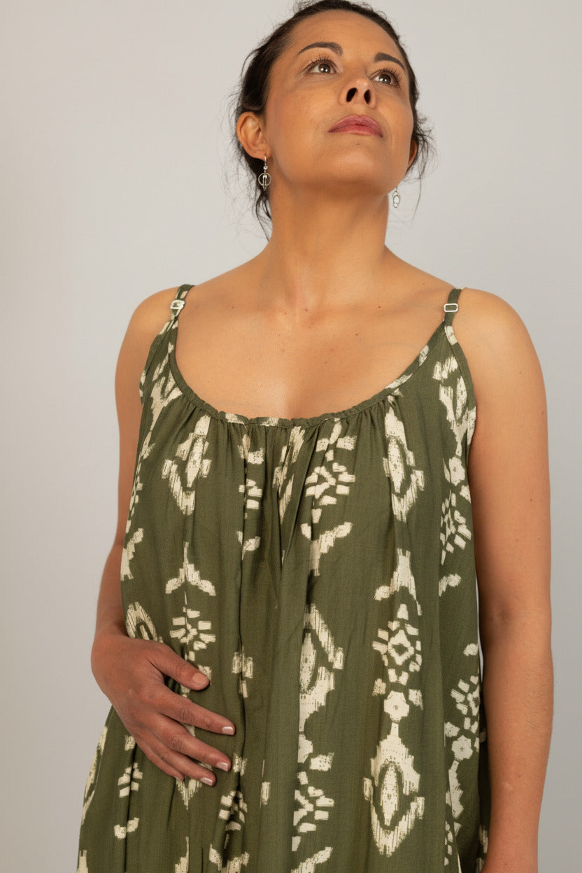 Woman wearing a green patterned dress against a white background